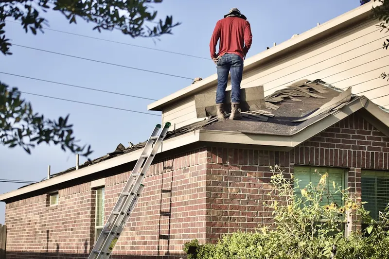 Professional roofer working on a residential roof in Sylvan Lake